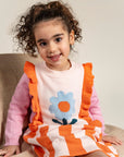 Toddler wearing Petal Playtime Cotton Knitted Dress with pink sleeves, orange ruffles, and a blue flower design. Cozy, soft cotton material, perfect for casual fall/winter outfits for toddlers.