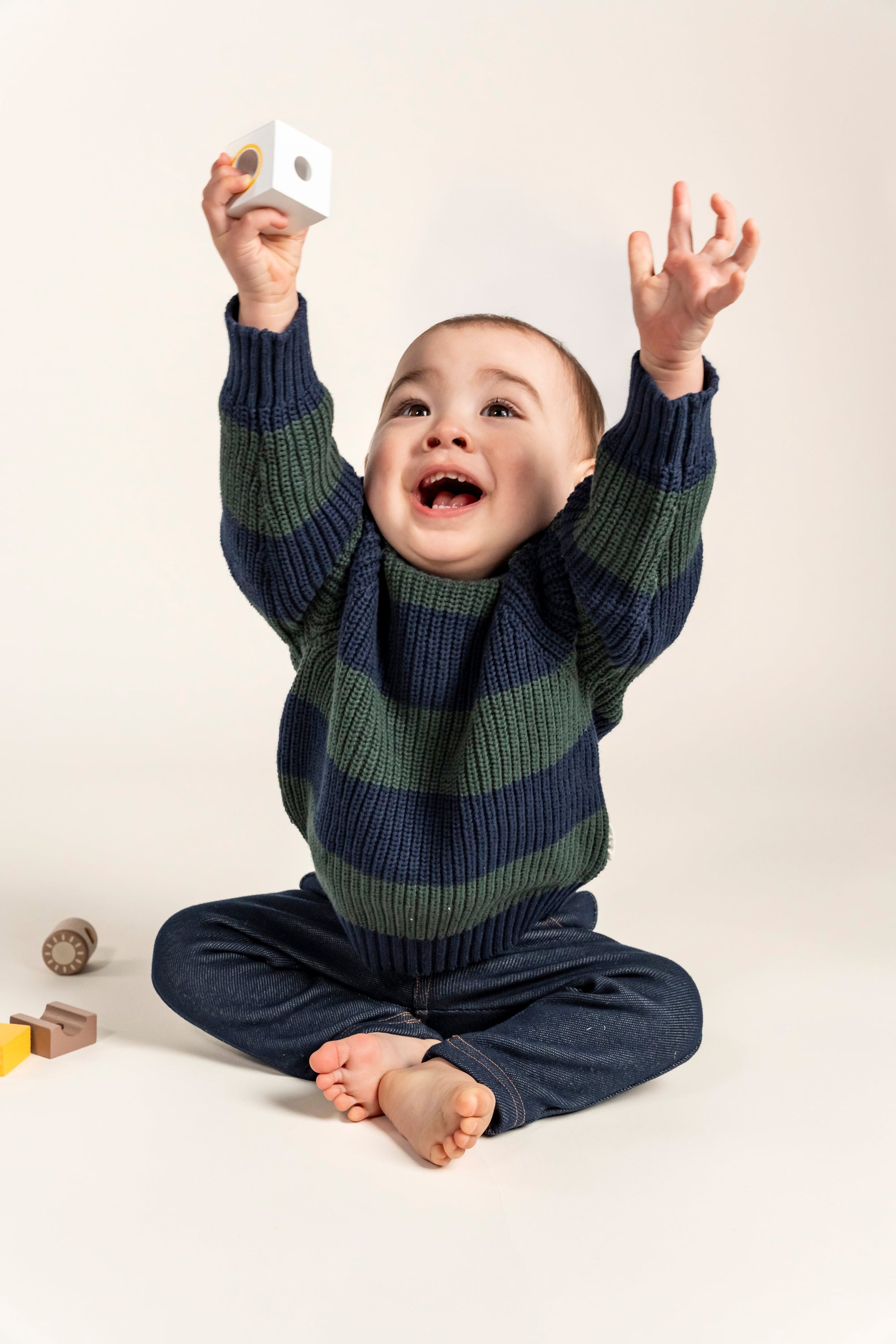 Playful Navy &amp; Forest Green Striped Knit Jumper for toddlers, perfect for cozy winter days. Made with soft cotton for ultimate comfort and warmth, this classic striped design ensures a stylish look.