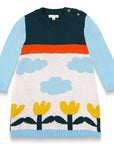 Cloudy Daydream Cotton Knitted Sweater Dress features a vibrant design with light blue sleeves, cloud patterns, yellow tulips, and a soft cotton blend. Long-sleeved, perfect for toddlers in cooler weather.